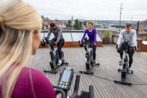 A Rooftop Cycling Class Using SportsArt's G516 Cycles.
